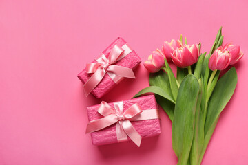 Gift boxes and beautiful tulip flowers on pink background. Hello spring