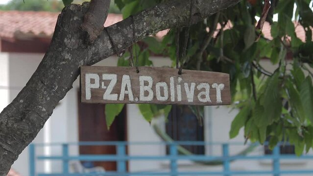 View of a small wooden sign with the name of Plaza Bolivar, located in the town of Chuao, Venezuela