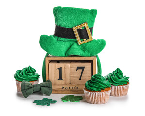 Tasty cupcakes for St. Patrick's Day, cube calendar with date MARCH 17, leprechaun hat and clovers...