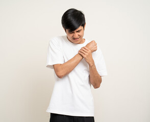 The young man has a skin disease problems. He has an itch. He scratched his skin infection. Age around 25 Wearing white shirt standing on isolate background