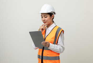 Asian engineer worker woman or architect with white safety helmet standing on isolated white background. Mechanic service factory Professional job occupation in uniform working with tablet