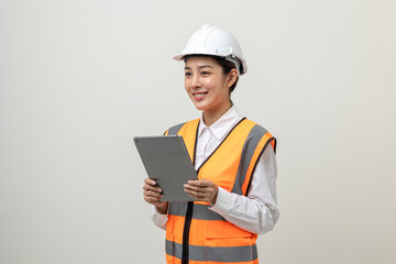 Asian engineer worker woman or architect with white safety helmet standing on isolated white background. Mechanic service factory Professional job occupation in uniform working with tablet
