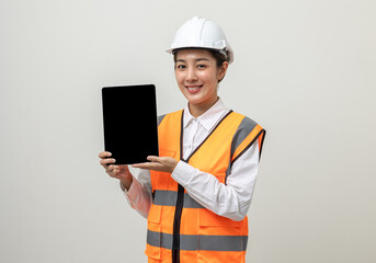 Asian engineer worker woman or architect with white safety helmet standing on isolated white background. Mechanic service factory Professional job occupation in uniform working with tablet