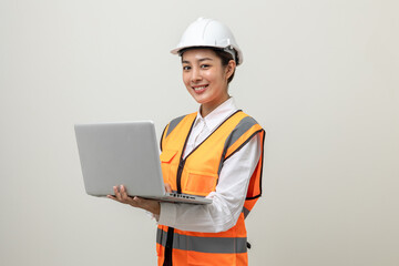 Asian engineer worker woman or architect with white safety helmet standing on isolated white background. Mechanic service factory Professional job occupation in uniform working with laptop computer