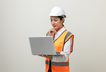 Asian engineer worker woman or architect with white safety helmet standing on isolated white background. Mechanic service factory Professional job occupation in uniform working with laptop computer