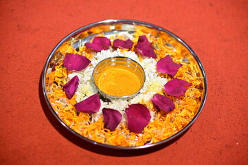 Plate with Turmeric Powder for Hindu Ceremony. Bowl and Petals. Haldi ceremony. Maharashtra Culture. Hindu Worship and Ritual.