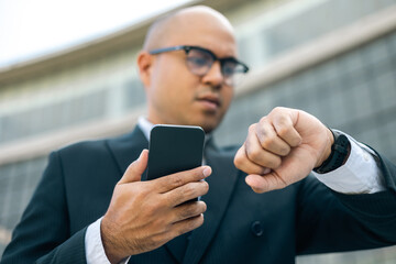 Rush hour. Senior manager business man in suit looking watch hurry go to working at the office...