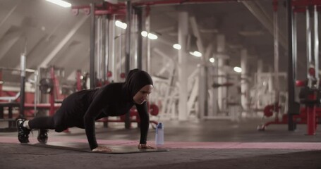 Muslim sportswoman doing push ups