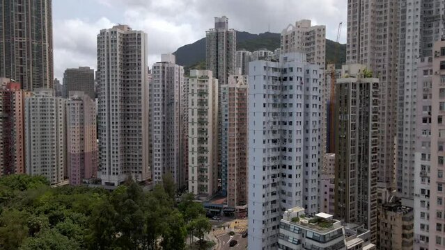 Aerial view of the Hong Kong flats and skyscrapers. Housing estates in Kennedy town. Drone lifting up. High-risers. Apartments. Asia. China. 