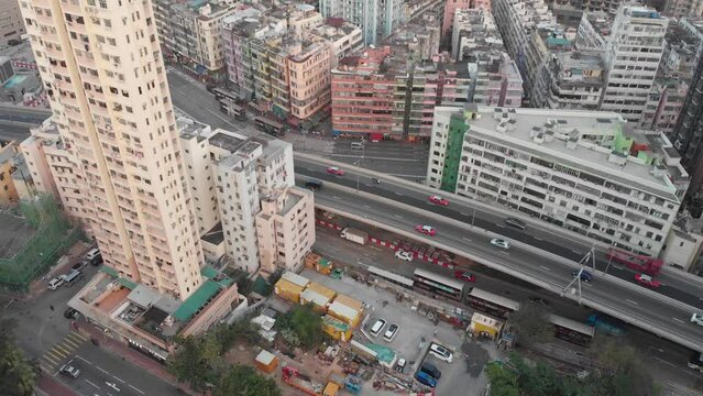 Hong Kong roads with traffic between old buildings in Kowloon. Taxi and bus. Colourful residential buildings. Popular travel destination in Asia. China. 