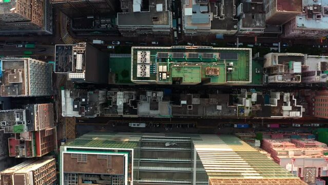 Drone aerial shot of Hong Kong high-rises, rooftops and streets. China. Asia. 