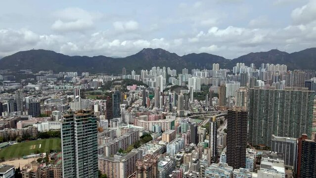 Hong Kong skyline, mountains in the background. Densely populated city. Popular travel destination in China. 