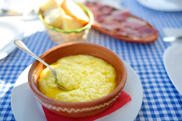 Traditional rustic treat in Montenegro is kachamak. Kachemak is a corn porridge mixed with crushed potatoes and kaymak, sheep cheese. It is served with cold milk, sour milk or yogurt.