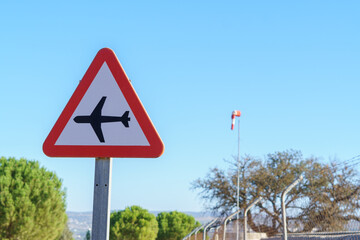 aircraft traffic sign in the background a blue sky and a windsock