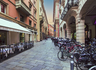 Bicycles and scooters parked in the historic centre of Bologna, Italy.