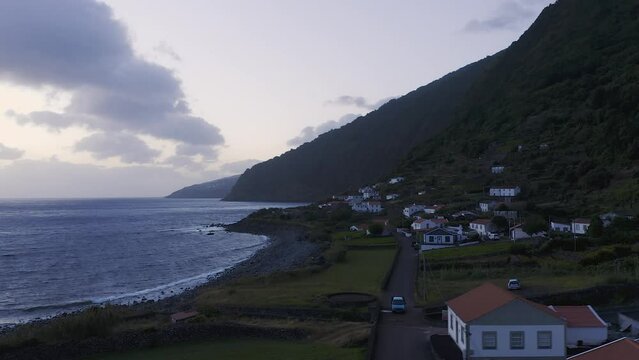 rural coastal village in lush green cliffs on blue hour, Faj&atilde; dos Vimes, S&atilde;o Jorge island, the Azores, Portugal