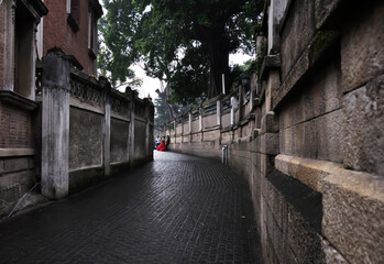 clean and quiet old alley with people taking wedding photos