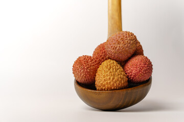 fresh lychees in a wooden spoon