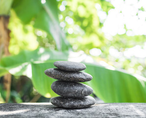 Obraz na płótnie Canvas Stack Stone on Blur Plant Growth Tree wit Bokeh Background,Texture Circle Pebbles Pyramid on Wood Nature,Concept for Health spa Aromatherapy,Meditation Natural,Calm Buddhism.