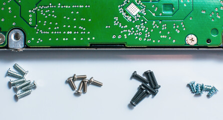Micro screws with white background and hard disk