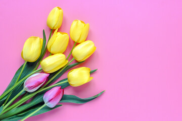 Bouquet of yellow tulips on pink background Top view Flat lay Holiday greeting card Happy moter's day, 8 March, Valentine's day, Easter concept Copy space Mock up