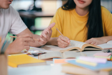 An asian students are reading books and study, Tutoring together.