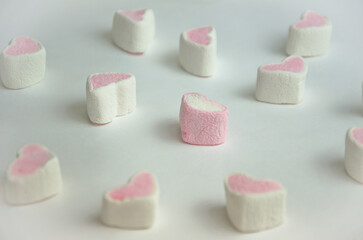 marshmallow on a light background in the form of hearts