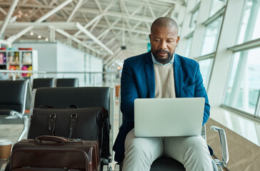 Black man, laptop and luggage at airport for business travel, trip or working while waiting to...