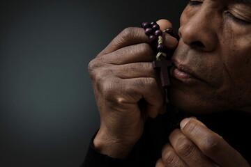 man praying to god with grey black background with people stock photo