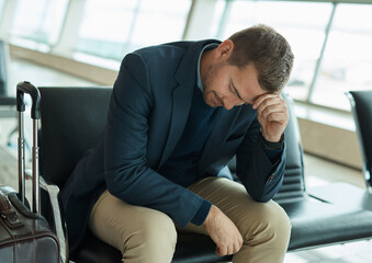 Airport, sad and headache of man waiting to travel, frustrated or depression in transport delay,...