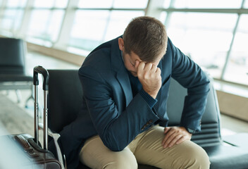 Airport, headache and stress man waiting to travel, frustrated and sad for transport delay, crisis or problem. Immigration, anxiety and person thinking, fail or mistake for international flight news