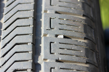Close up of small stones and debris caught in a vehicle tire tread