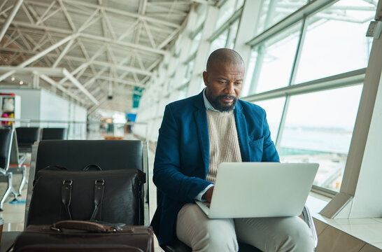 Airport travel, laptop and business man review finance portfolio feedback, stock market database or investment. Online economy, forex account manager and African trader trading NFT, bitcoin or crypto - Powered by Adobe