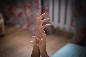 Women's hands in a room in daylight