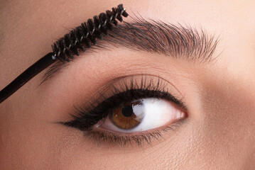 Close up eyebrows with eyebrow brush. Care for brows, eyebrows lamination. Brow procedures. Long...