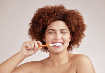 Happy woman, brushing teeth and toothbrush for clean and healthy mouth on studio background. Face...