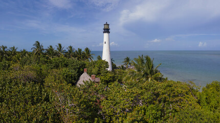Fototapeta na wymiar Panorama of Bill Baggs Cape Florida State Park against ocean in Miami Florida. The historic Cape Florida Old Tower Lighthouse and Cape Florida Beach can also be seen on this sunny landscape.