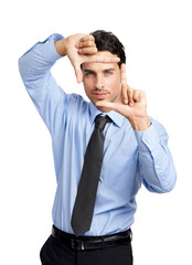 An attractive young male model in a formal shirt and tie or a businessman making a frame with his fingers isolated on a png background.