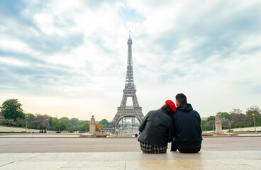 Fototapeta na wymiar cheerful happy couple in love visiting Paris city centre and Eiffel Tower