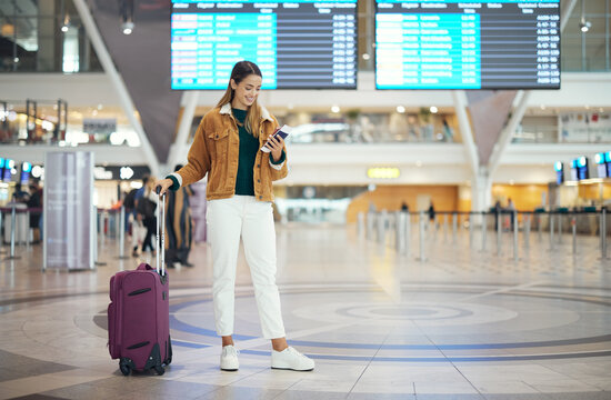 Travel, woman in airport and luggage for vacation, break and girl excited, smile and check boarding ticket. Female, lady and traveler with suitcase, international and departure with passport and trip