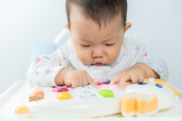 Baby sitting play in high chair,happiness baby,asian baby boy