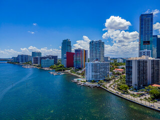 Miami Beach Florida skyline with Miami South Channel against blue sky in Florida. The modern high rise buildings and condominiums has an amazing view of the lagoon with boats.