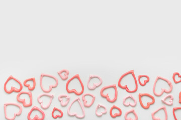 sweet meringue kiss cookies of heart shapes over white background, concept of St. Valentines Day, copy space