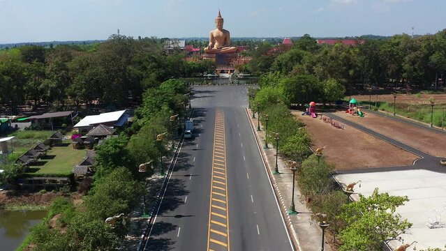 Aerial view of Wat Pikul Thong Phra Aram Luang or Wat Luang Por Pae temple with giant Buddha, in Sing Buri, Thailand
