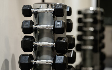 Naklejka premium A lot of dumb-bell used for weightlifting fitness exercises inside a gym. Sports industry concept photo.