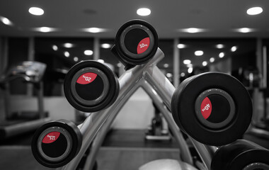 A lot of dumb-bell used for  weightlifting fitness exercises inside a gym. Sports industry concept photo.