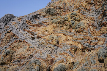 Schichtungen verschiedener Gesteinsformationen in einem Felsen