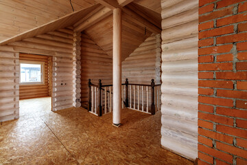 A two-story wooden cottage from the inside out in coniferous spruce pine green forest