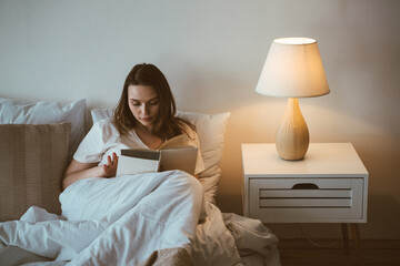 Woman reading before going to sleep