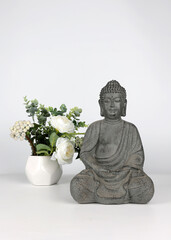 Buddha Statue with flower vase aside
